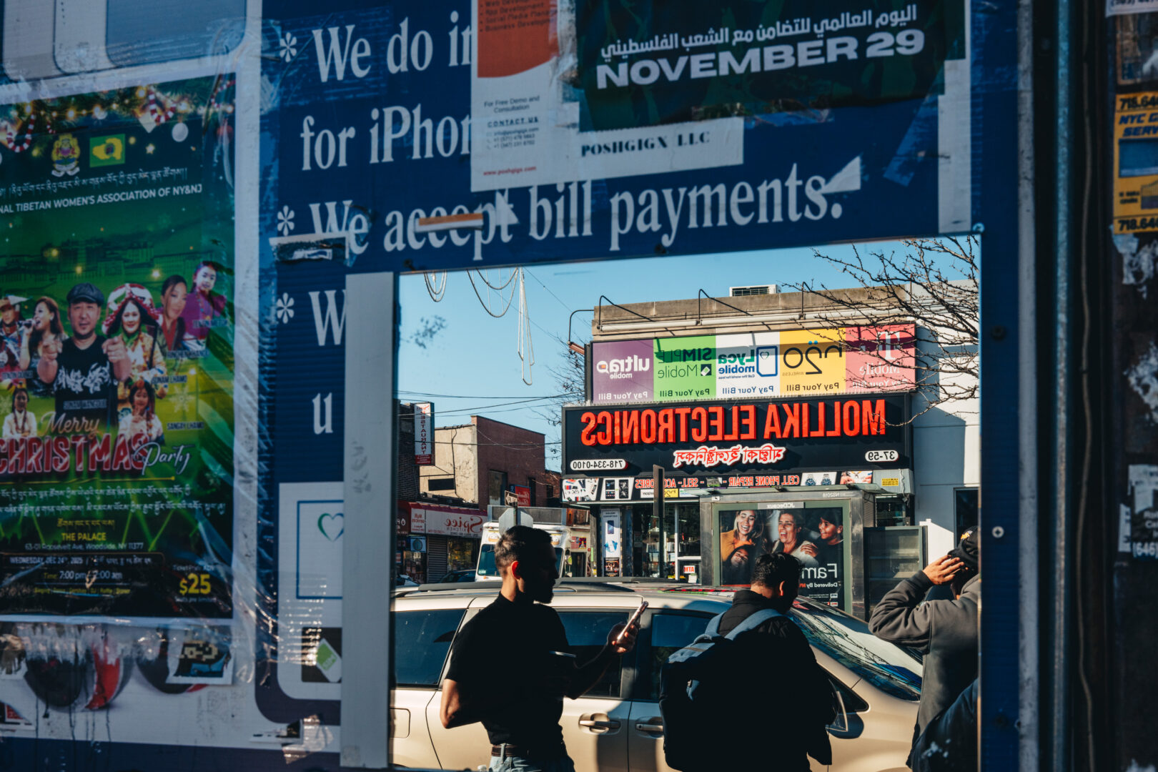 Mallika Electronics, Queens
Layered signage and reflections overlap across the storefront window.