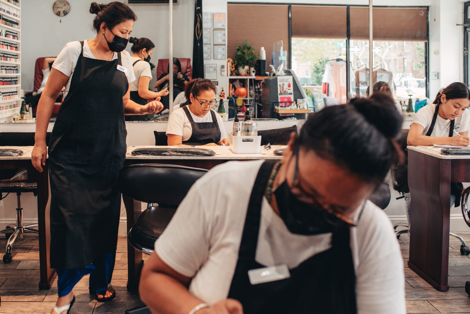Nail salon, Astoria Queens
Workers engaged in routine tasks during a regular workday.