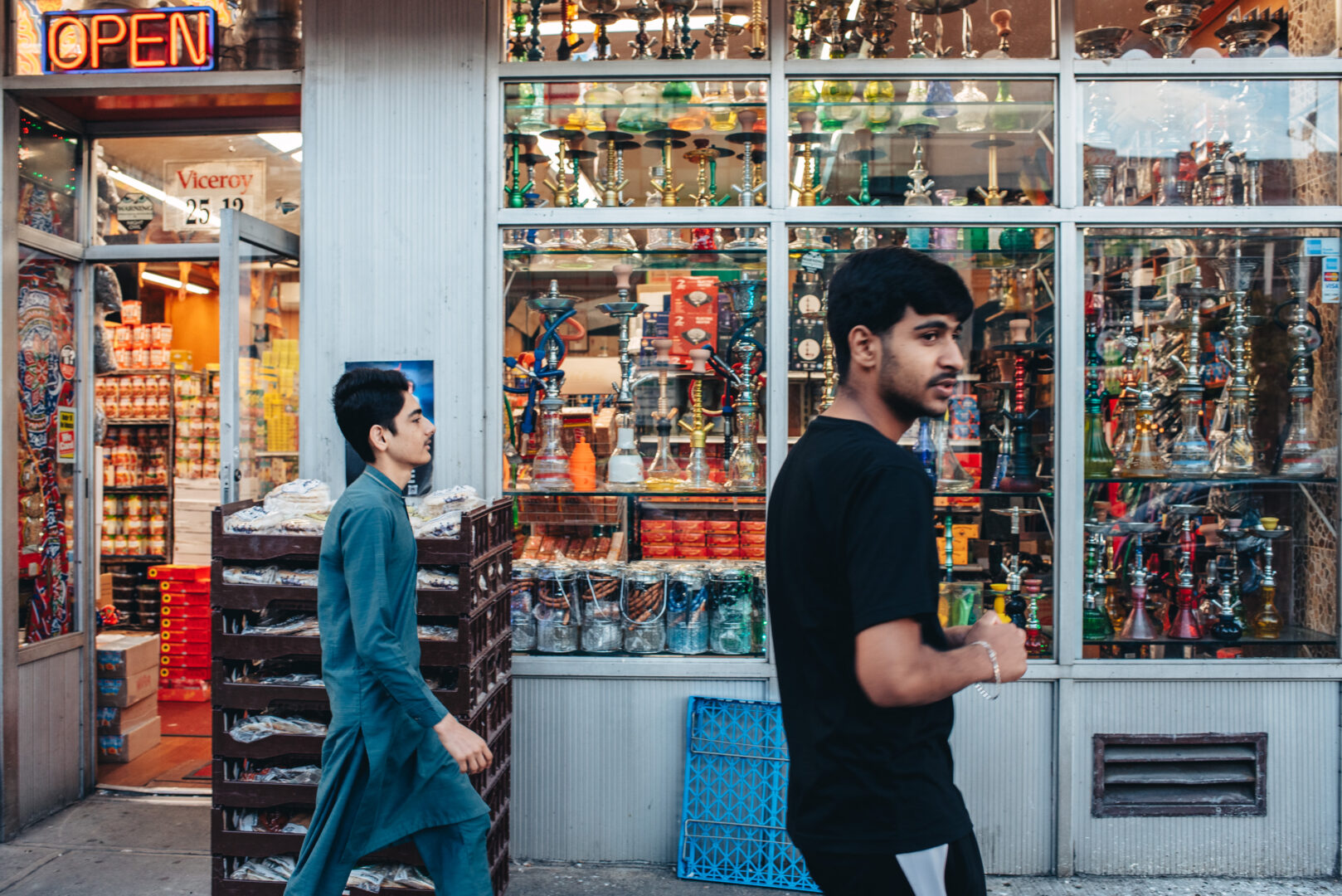 Hookah shop window, Queens
Interior objects visible through glass as pedestrians move past.